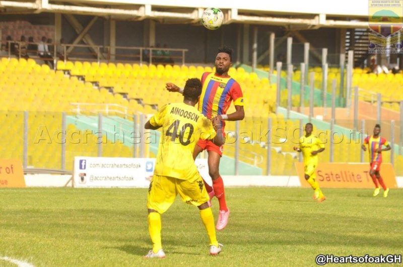 Abeiku Ainooson [40] gives a pass with the head as Kwame Kizito watches on