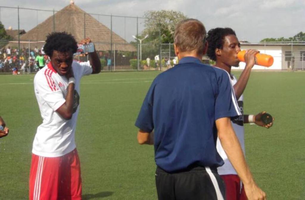 Majeed Ashimeru [Right] taking water whilst listening to his coach