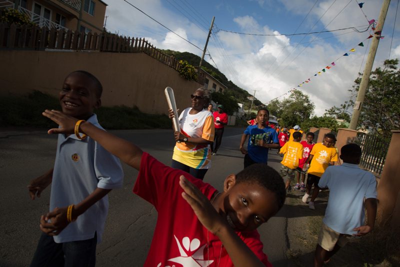 Students from Willard Wheatley Primary School run with the Baton
