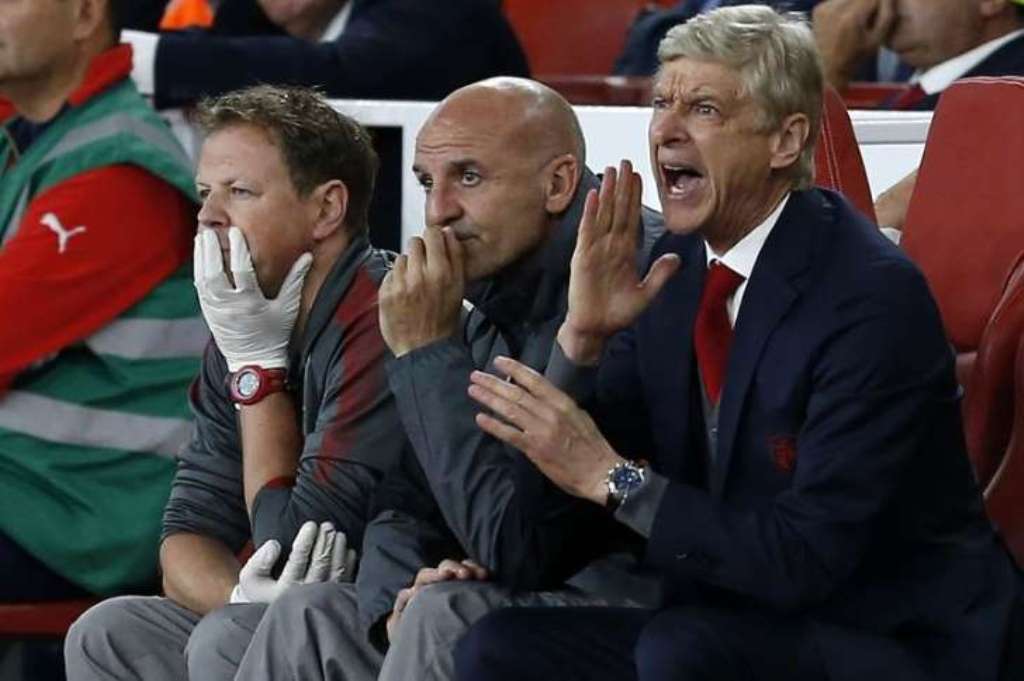 Arsene Wenger instructing his players from the dugout