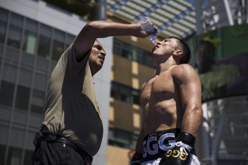 Abel Sanchez [trainer] gives Golovkin water to quench his thirst