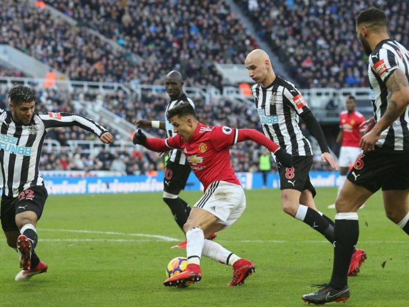Alexis Sanchez trying to tear his way through the Newcastle defence