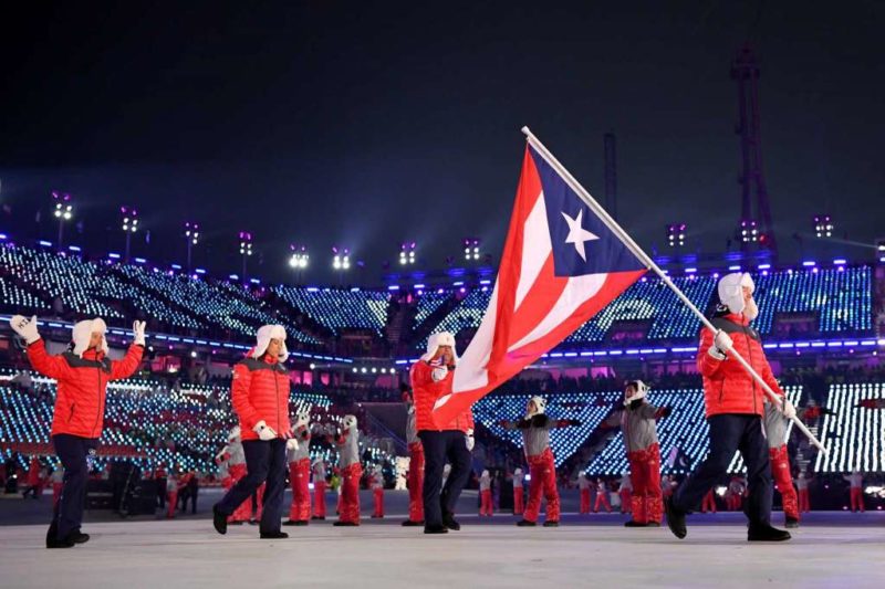 Flag bearer Charles Flaherty of Puerto Rico and teammates arrive at the stadium during the Opening Ceremony of the PyeongChang 2018 Winter Olympic Games