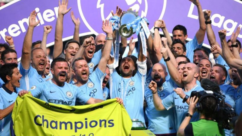 Pep Guardiola lifts the Premier League trophy with Manchester City