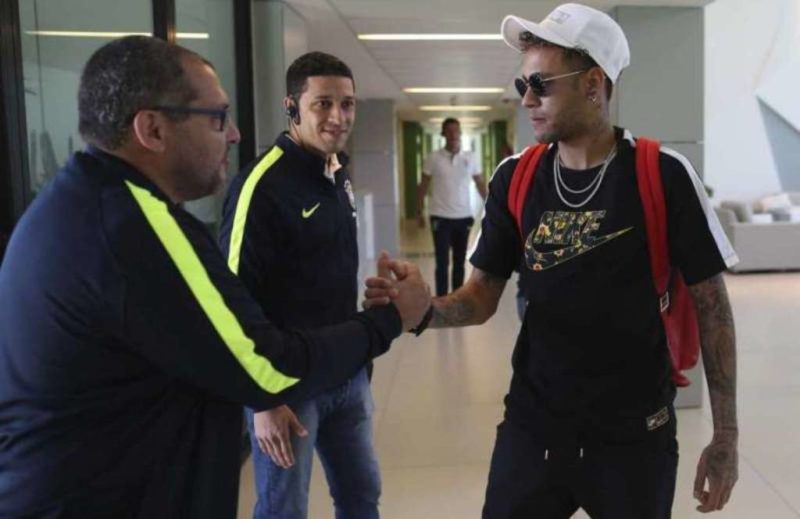 Neymar greets workers at the Granja Comary training center as he arrives to train in Teresopolis, Brazil
