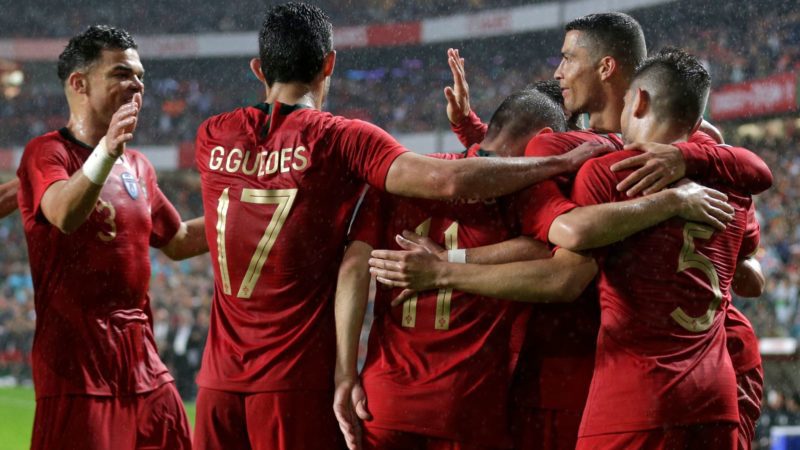 Portuguese forward Goncalo Guedes (2L) celebrates with teammates defender Pepe (L) and forward Cristiano Ronaldo (R)