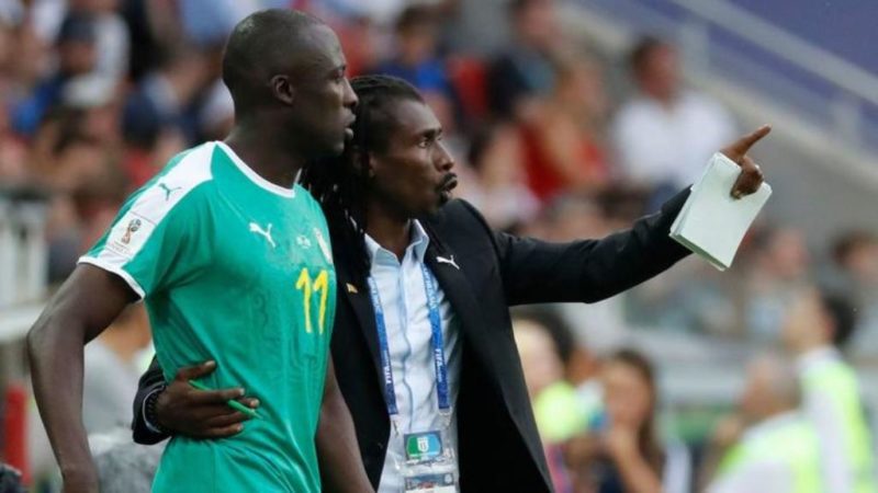 Senegal coach Aliou Cisse, right, talks strategy with Cheikh N'Doye