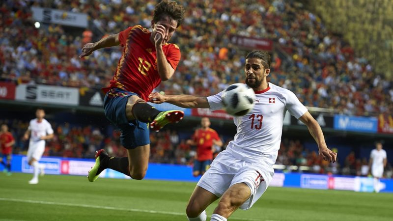 lvaro Odriozola of Spain competes for the ball with Ricardo Rodriguez (R) of Switzerland