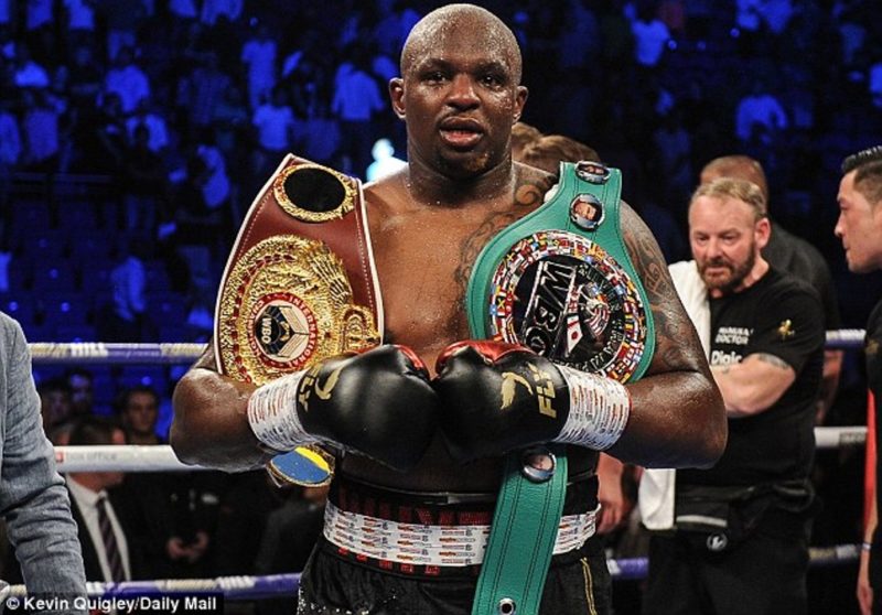 Dillian Whyte displaying his belts