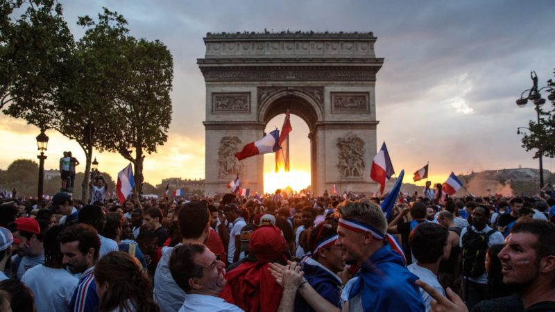 French football fans celebrate around the Arc de Triomph