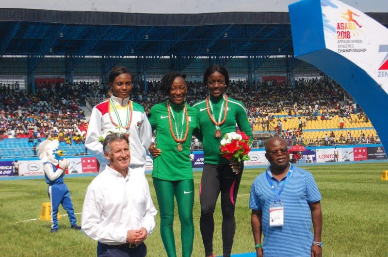 Marie Josee Ta Lou being flanged by Janet Amponsah [left] and Joy Udo Gabriel [right] on the medal podium