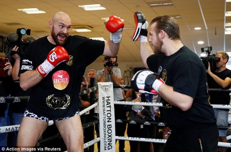 The former unified heavyweight champion Tyson Fury hits the pads