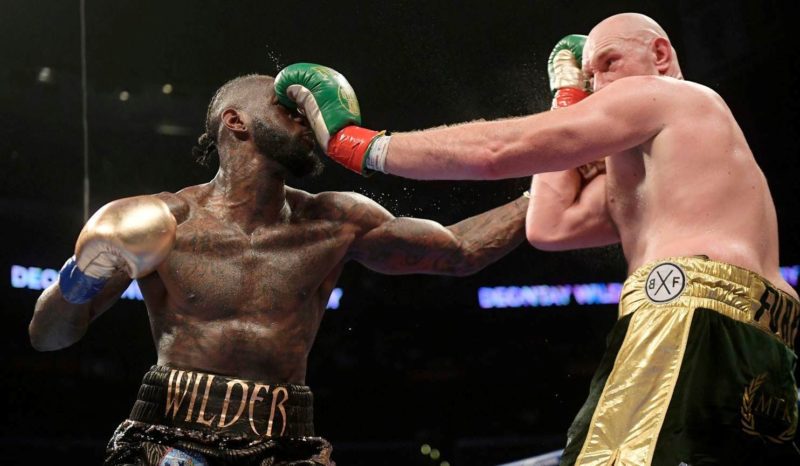 Deontay Wilder, left, and Tyson Fury, of England, trade punches