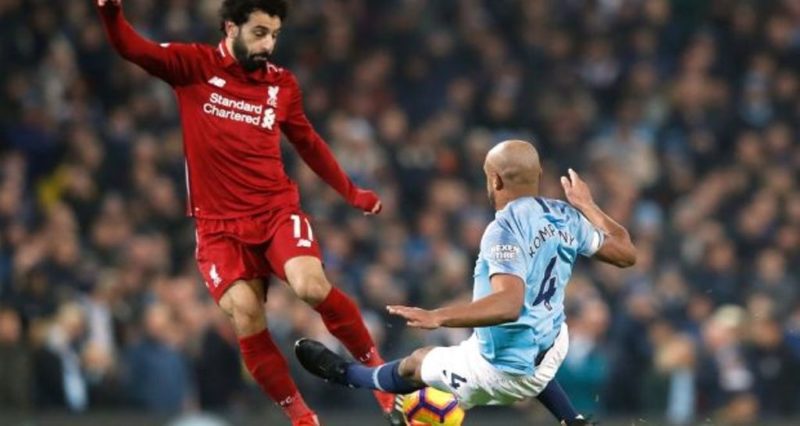Manchester City's Vincent Kompany tackles Liverpool's Mohamed Salah