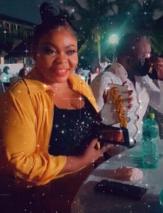 Mavis posing with her plaque
